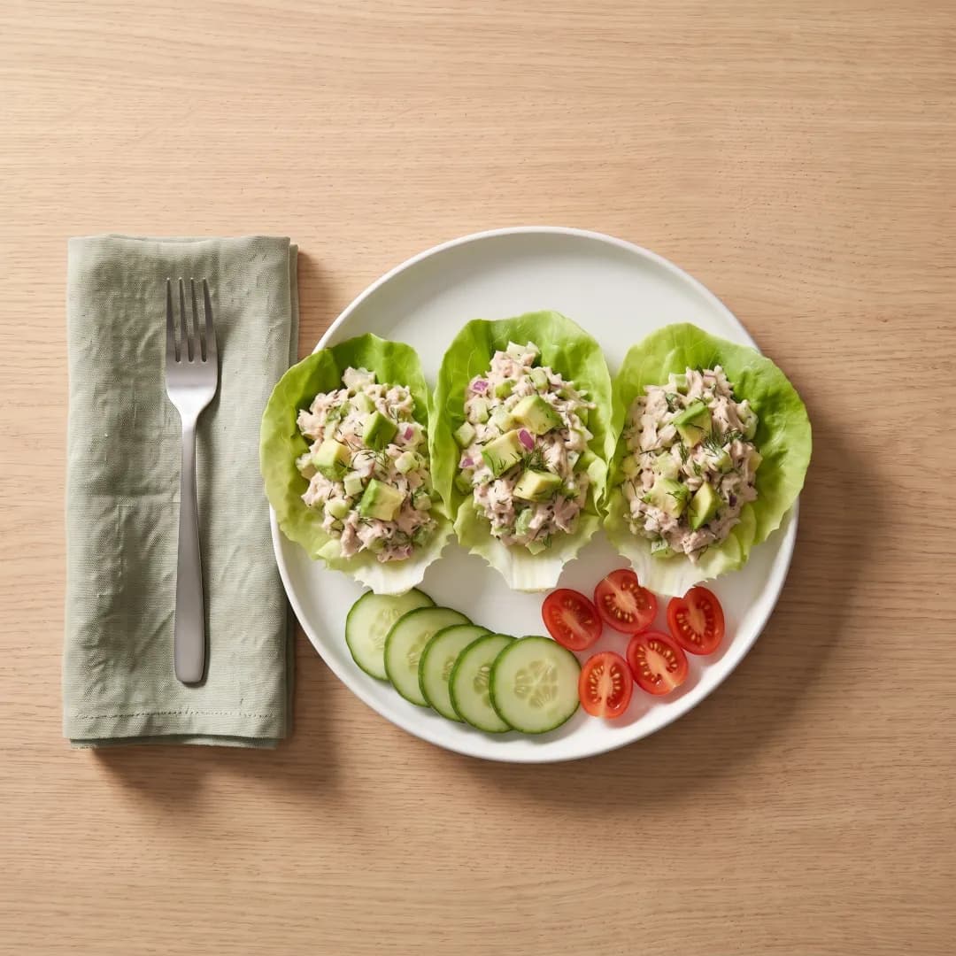 Tuna salad in butter lettuce cups with cucumber and tomatoes