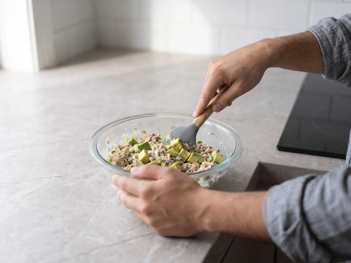 Folding avocado into tuna salad