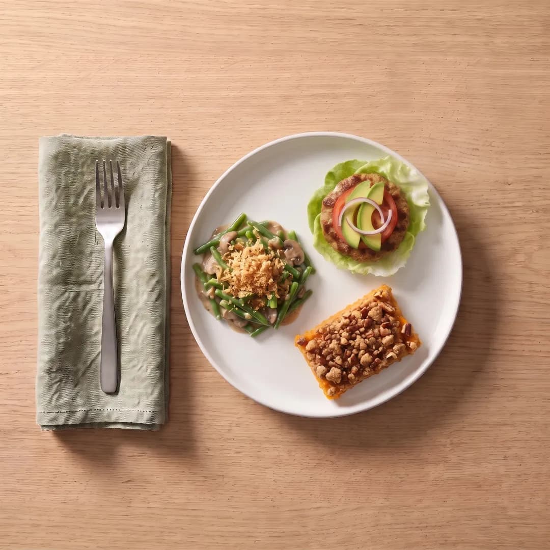 Plate with turkey burger, green beans and sweet potato casserole