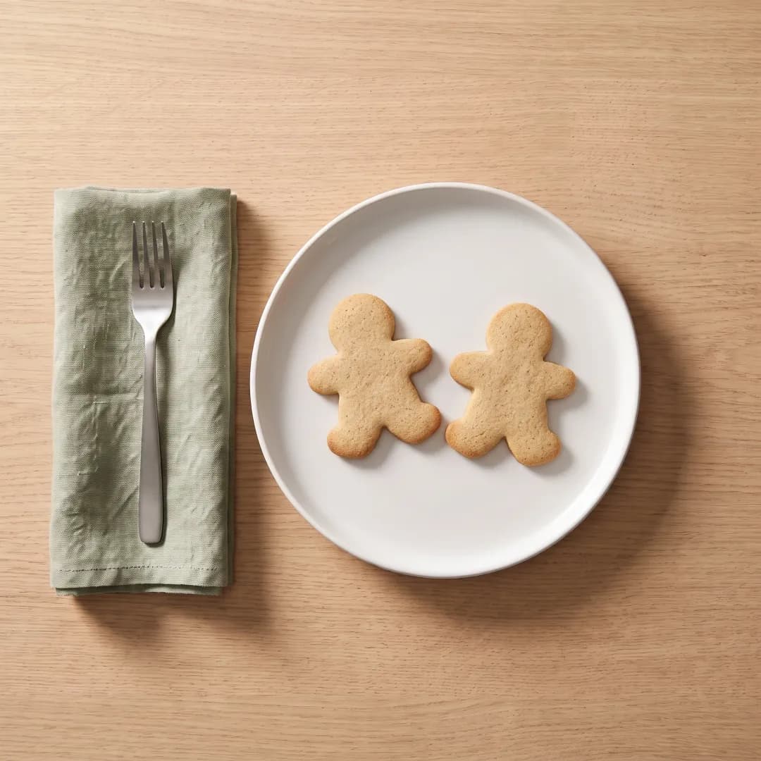 Two allulose-sweetened gingerbread cookies on a white plate