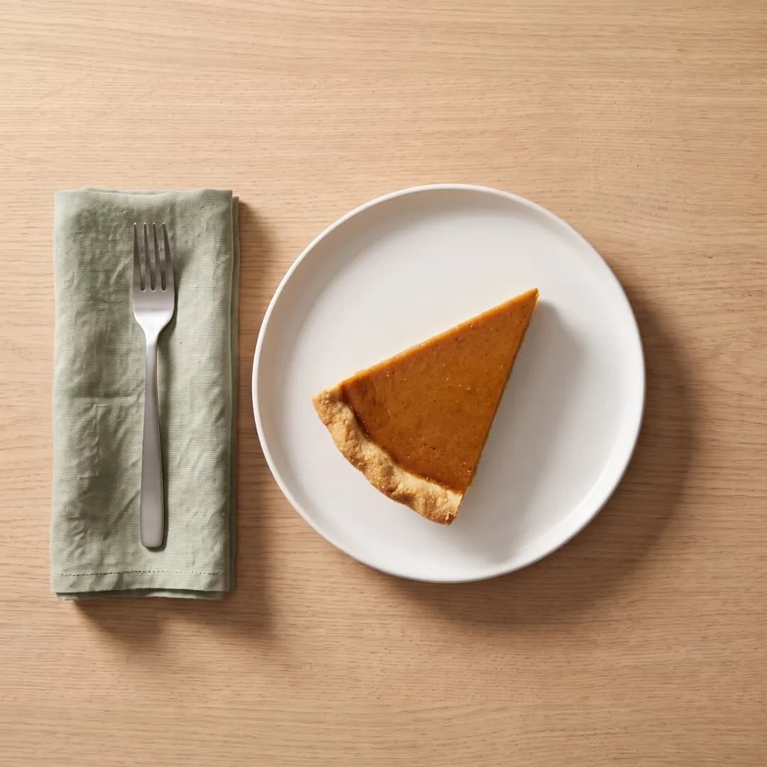 Slice of allulose-sweetened pumpkin pie on a white plate