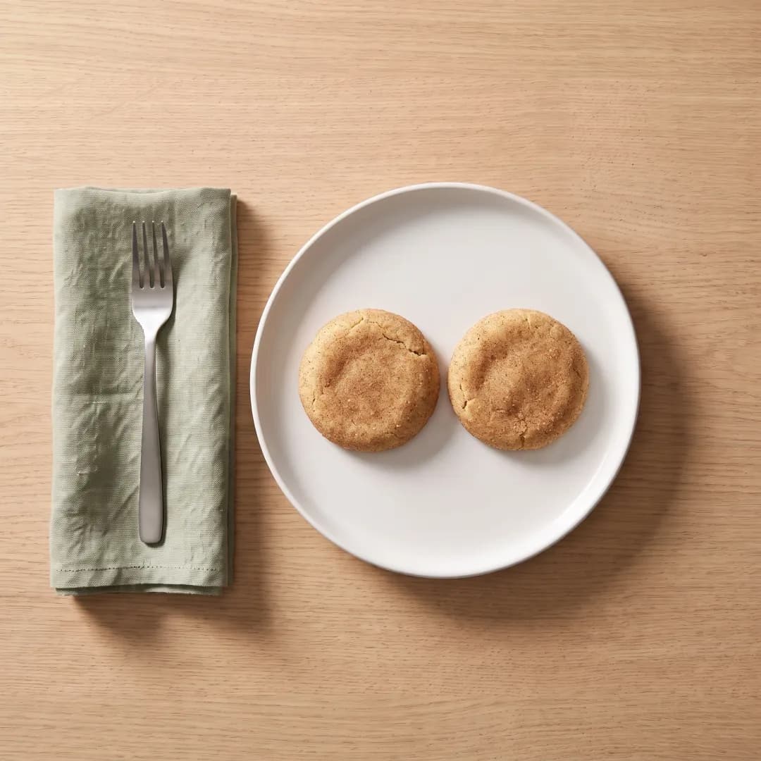 Two allulose-sweetened snickerdoodles on a white plate