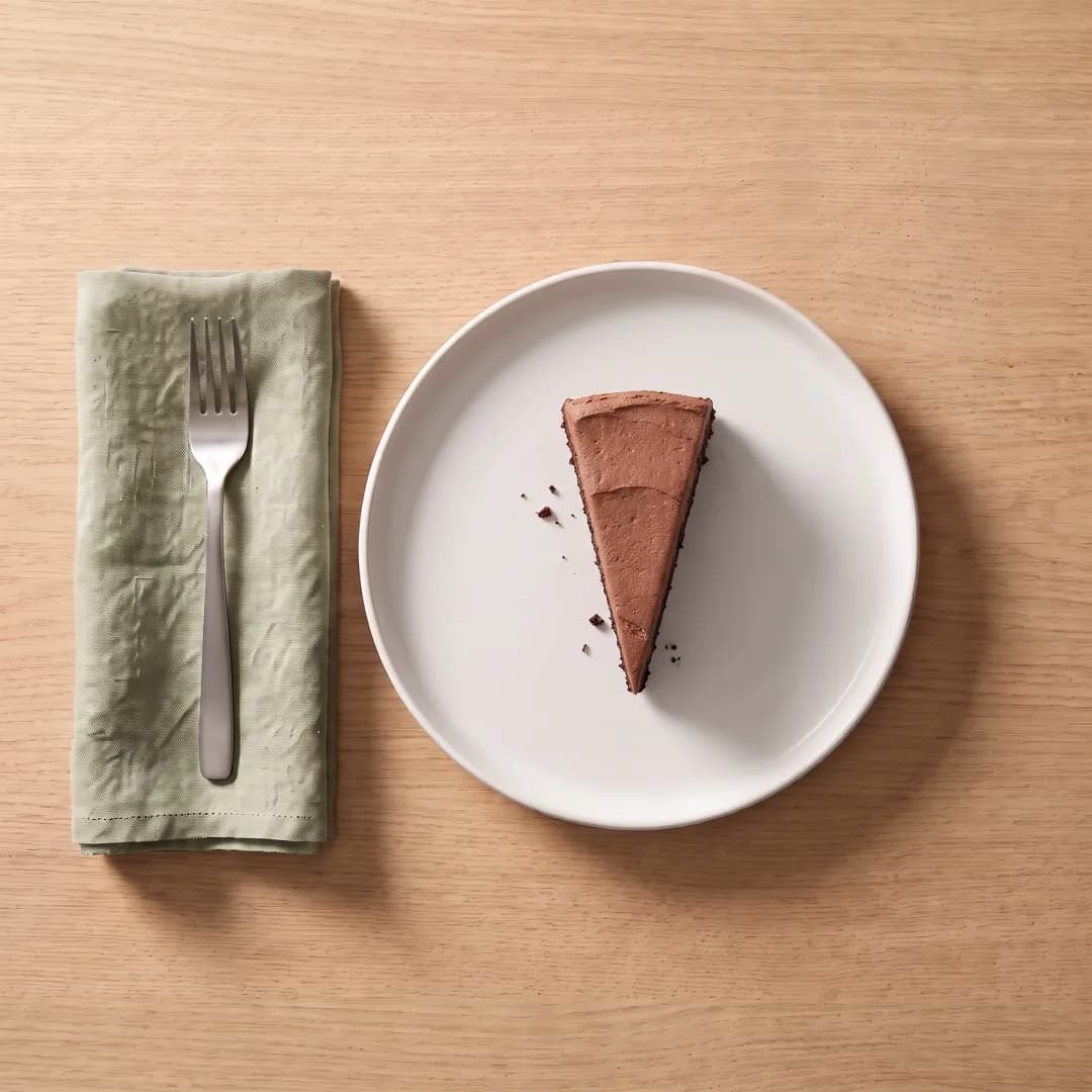 A slice of almond flour chocolate cake with cocoa frosting
