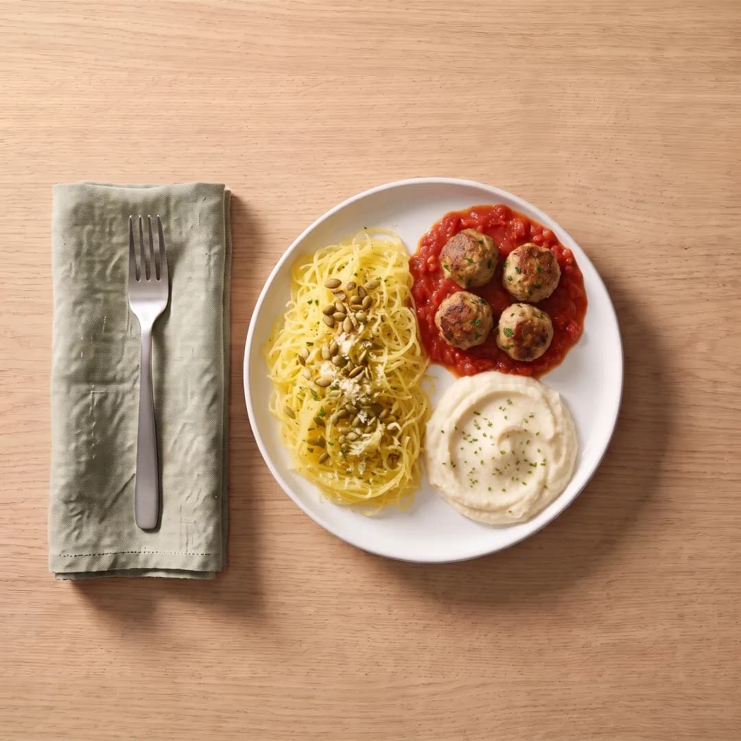 Plate with spaghetti squash, turkey meatballs and mashed cauliflower