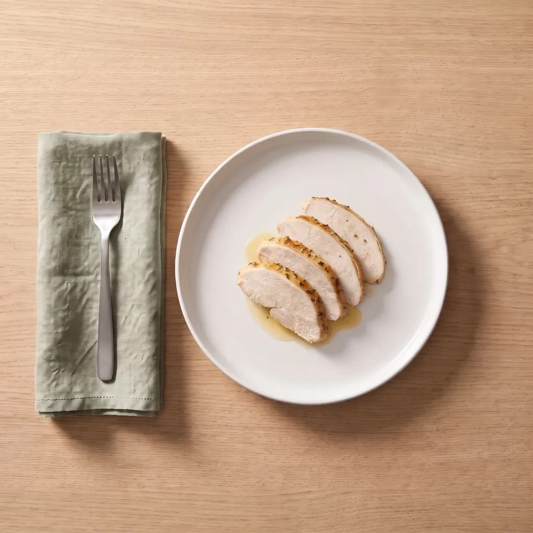 Sliced herb-roasted turkey breast on a white plate