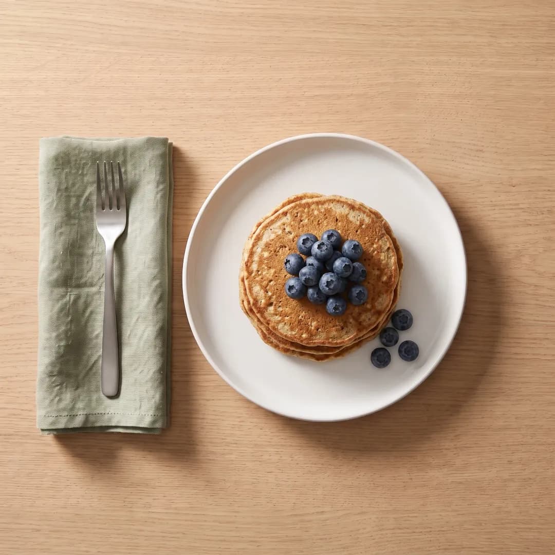 Stack of high-protein pancakes with blueberries