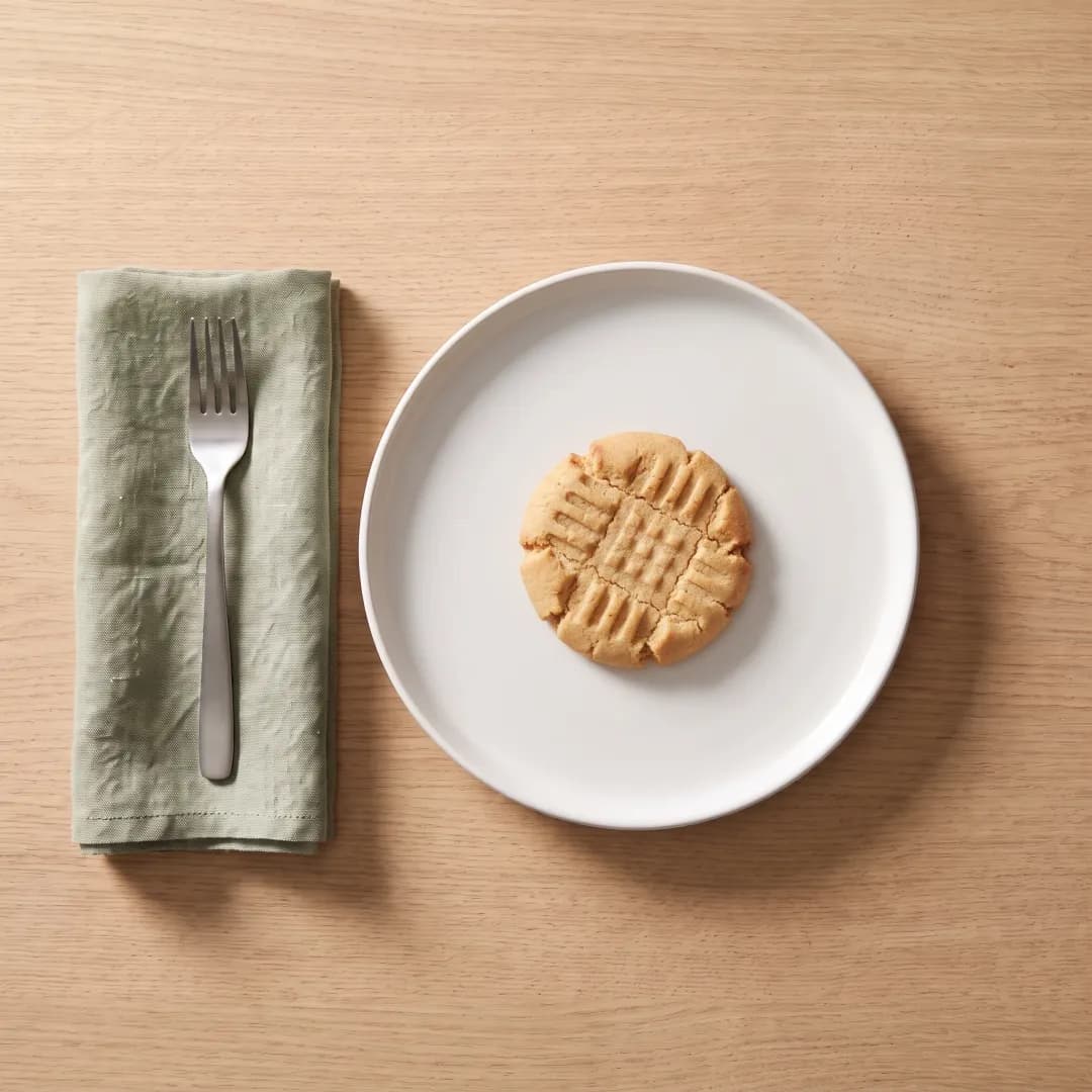 A peanut butter protein cookie on a white plate