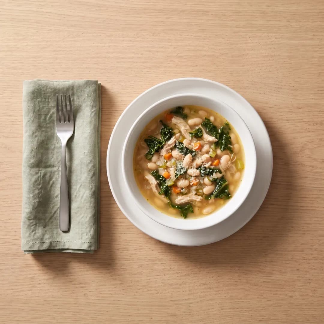Bowl of white bean soup with chicken and kale